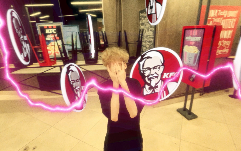 Сотрудник KFC вокруг которого летают логотипы KFC